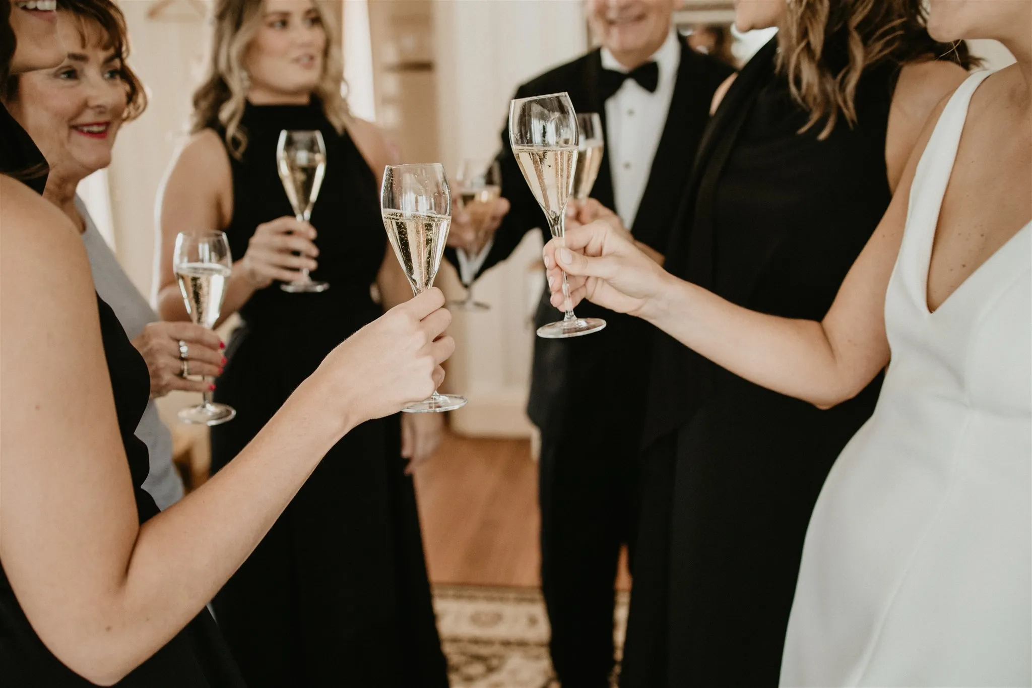 Friends holding champagne glasses chatting