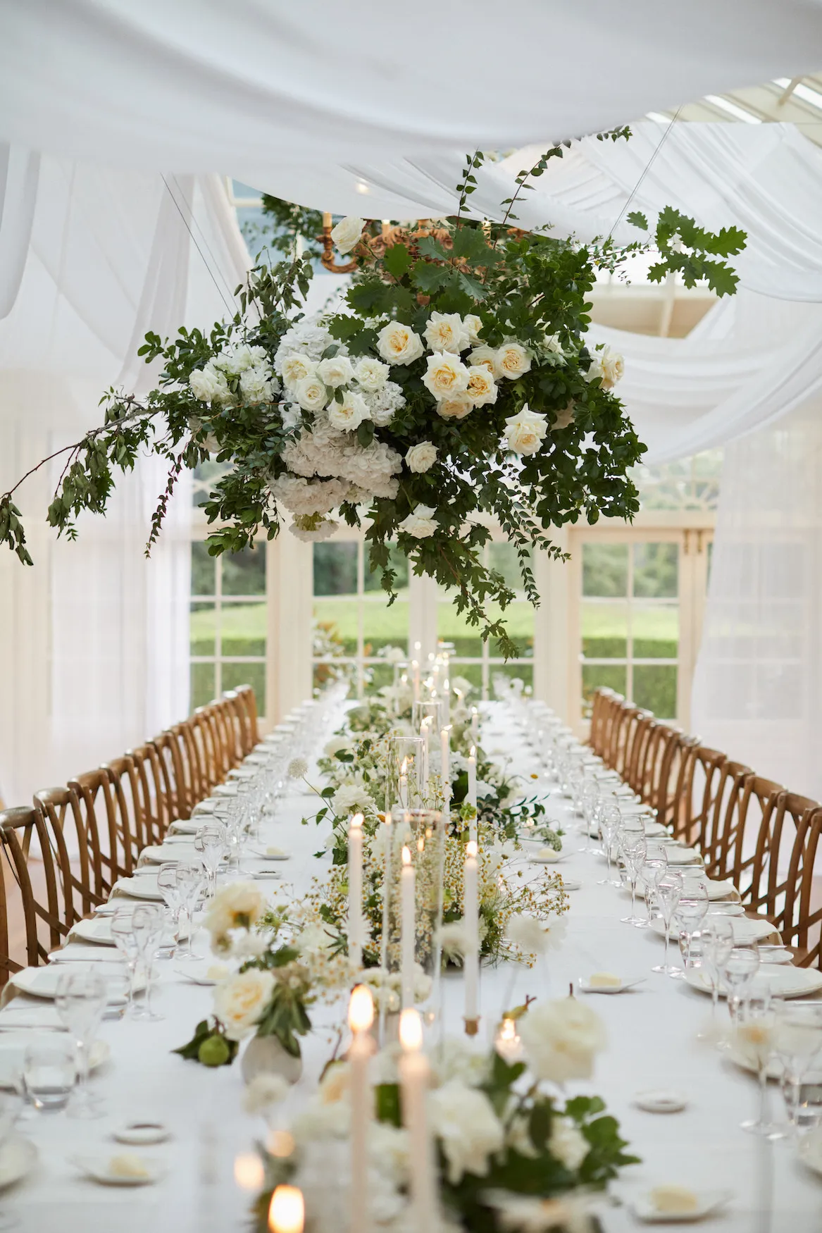 Wedding reception table with hanging flowers and drap