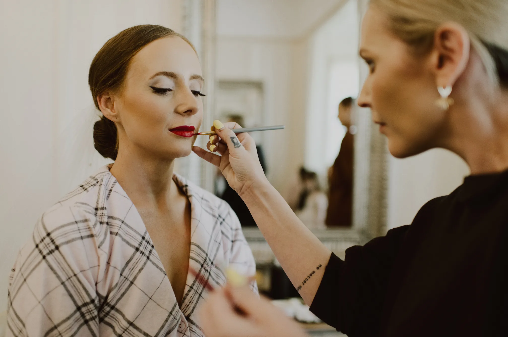 Bride having red lipstick applied