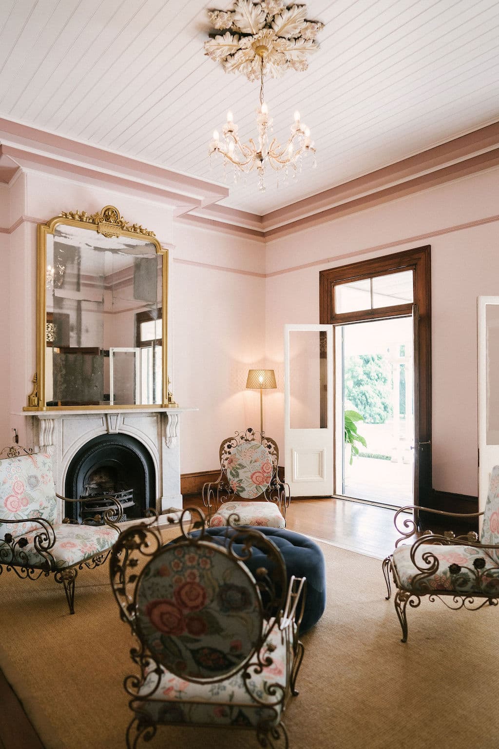 Sitting room with fireplace and gold chairs