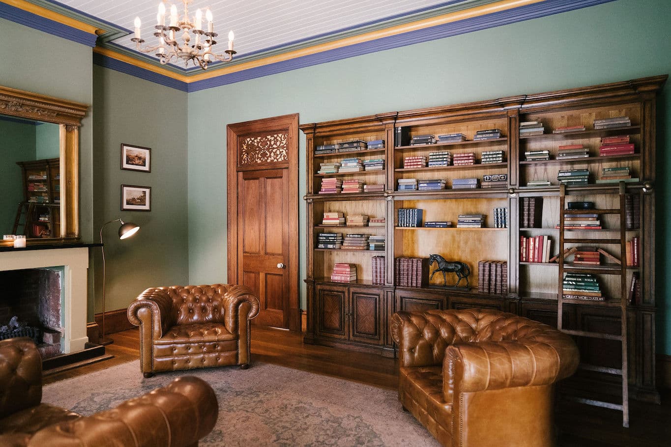 Library with fireplace and wooden bookshelf