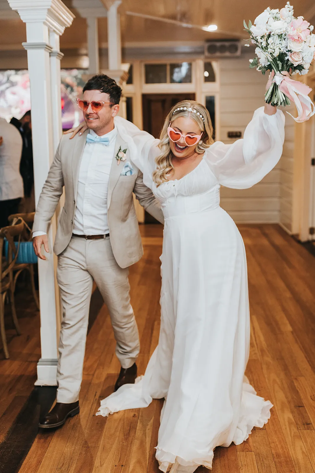 Bride and groom entering reception