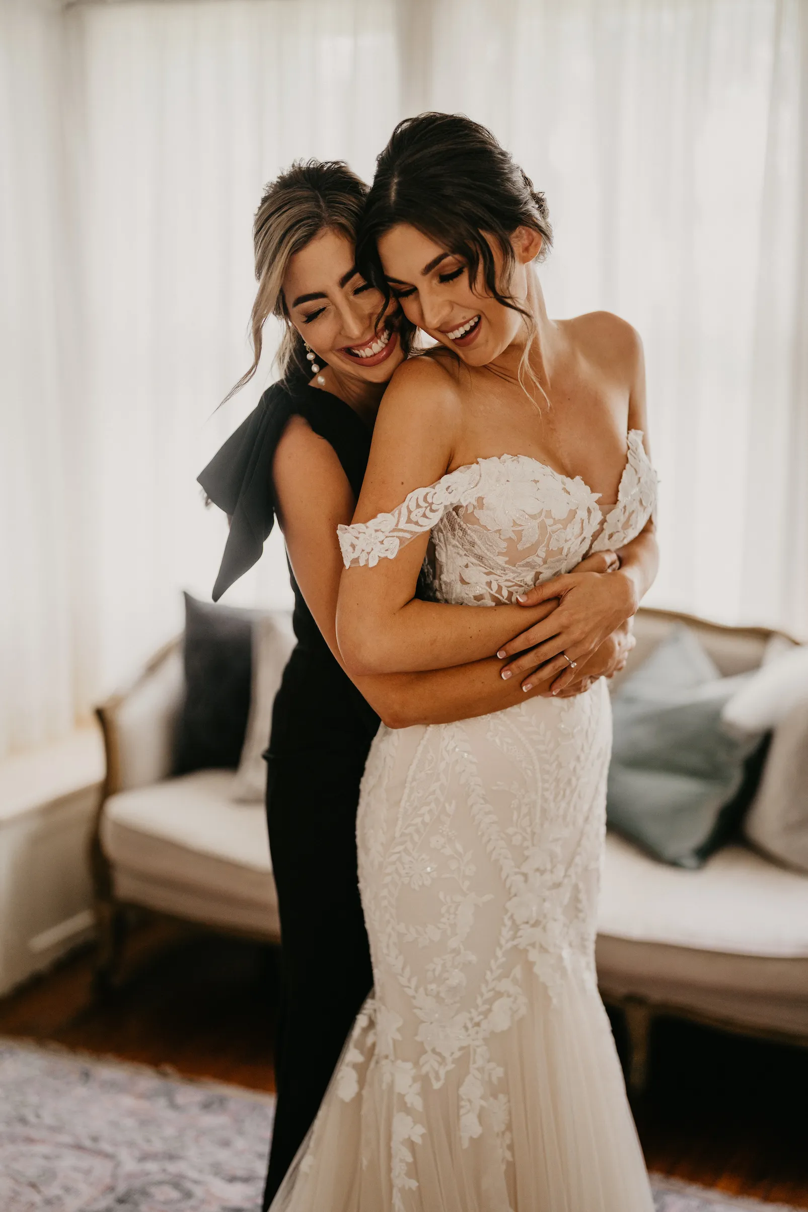 Bride and bridesmaid hugging